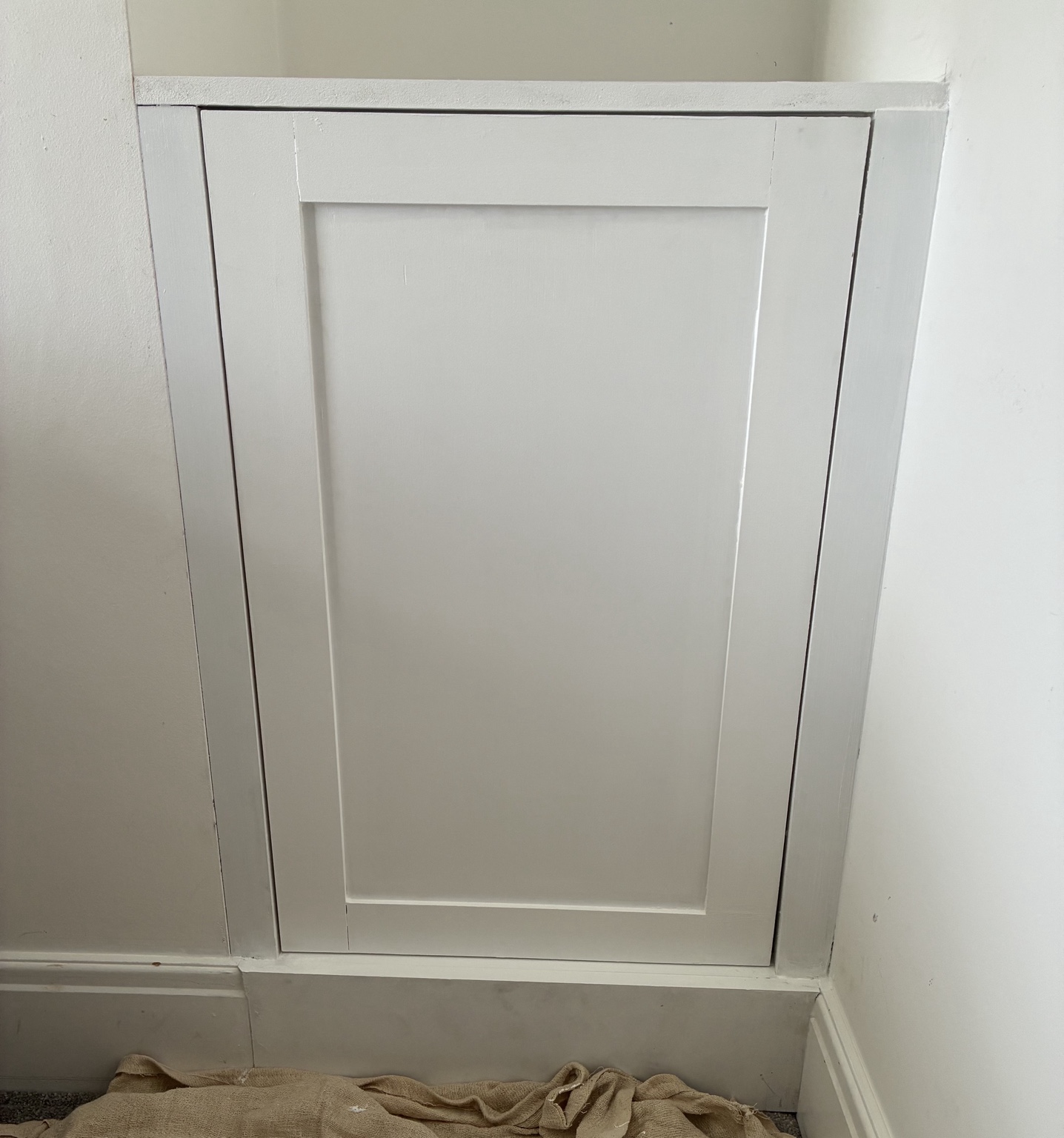 White made-to-measure cupboard door fitted into a wall