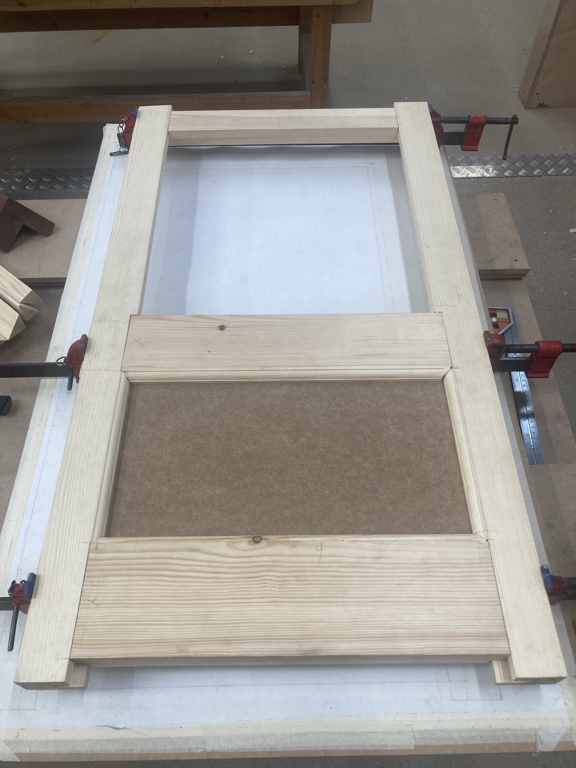 Green made-to-measure fitted cabinetry with open display shelving